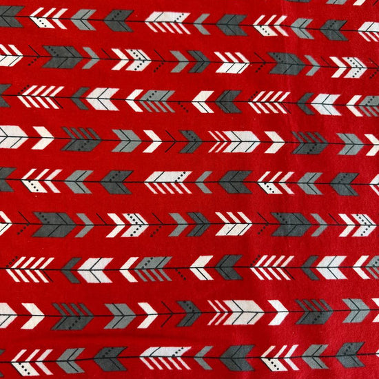 Red cotton flannelette fabric with white and gray arrow print pattern.