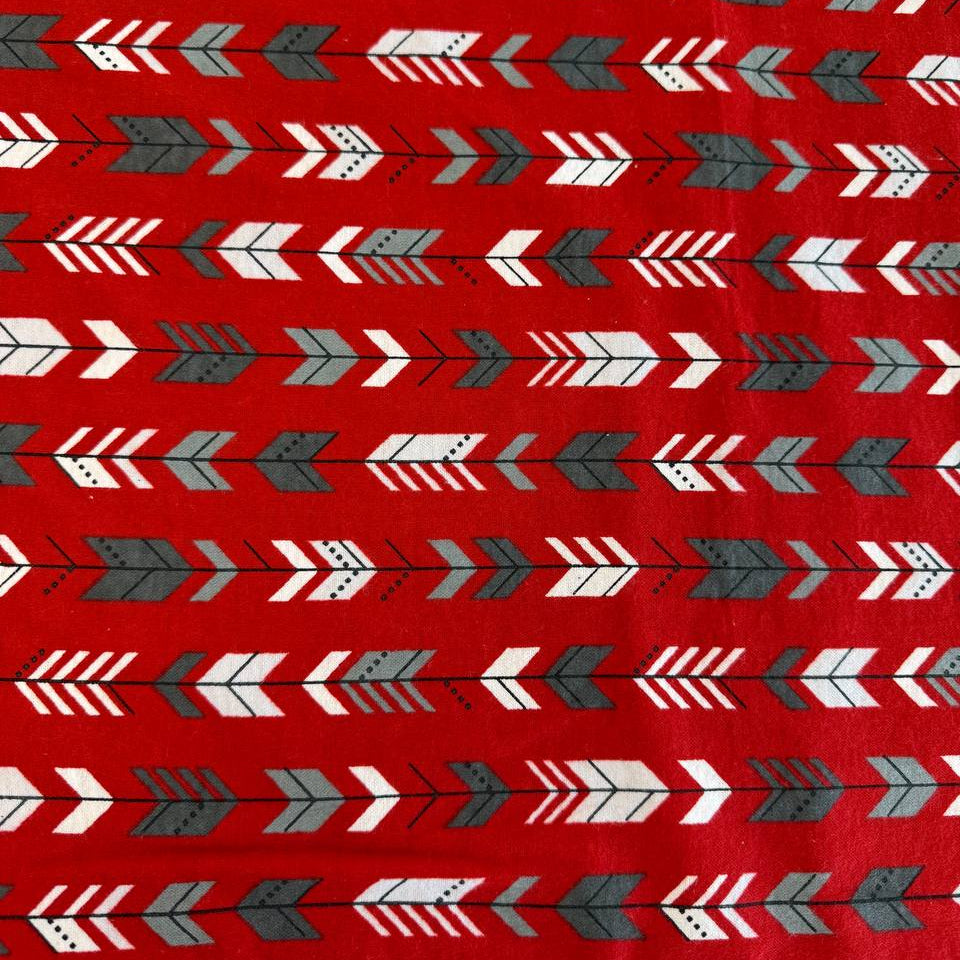 Red cotton flannelette fabric with white and gray arrow print pattern.