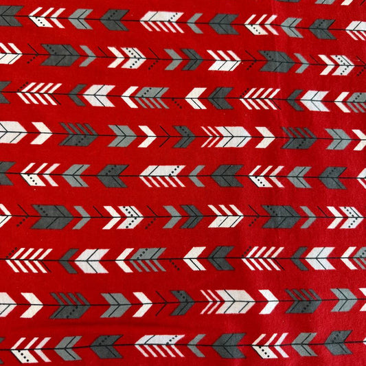 Red cotton flannelette fabric with white and gray arrow print pattern.