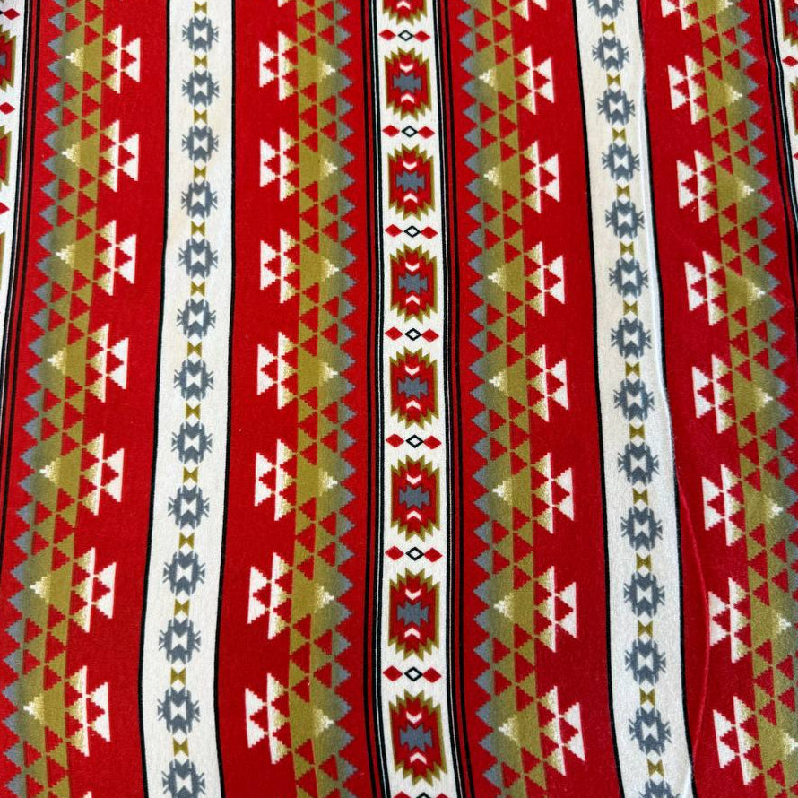 Red cotton flannelette fabric with southwestern stripe pattern in cream, gray, olive, and black tones.