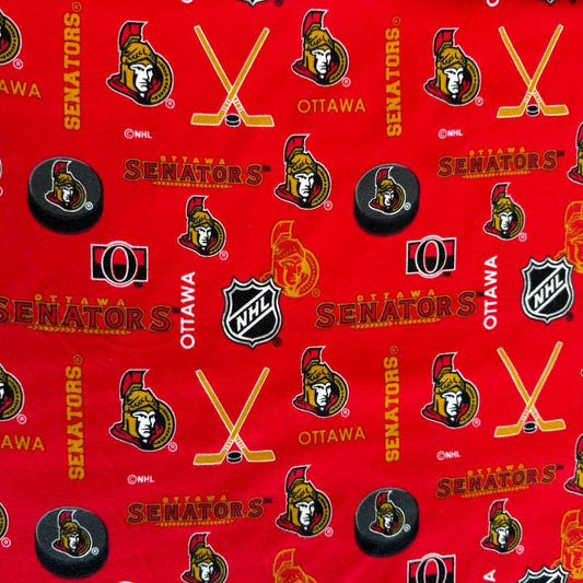 Ottawa Senators NHL cotton flannel fabric with hockey logos, pucks, and sticks on a bright background.