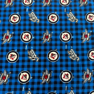 Winnipeg Jets NHL cotton flannel fabric with official team logos on a blue and black checkered background.