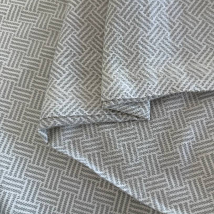 Prairie Gatherings 108 inch cotton flannel fabric by Primitive Gatherings for Moda Fabrics featuring a woven-style geometric print, available in warm tan and soft grey color variations.