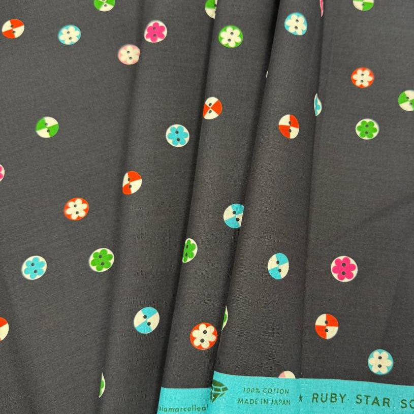 Moda 1800 Notion RS5208-17 Soft Black 100% cotton fabric by Ruby Star Society featuring colorful small button and floral motifs on a black background.