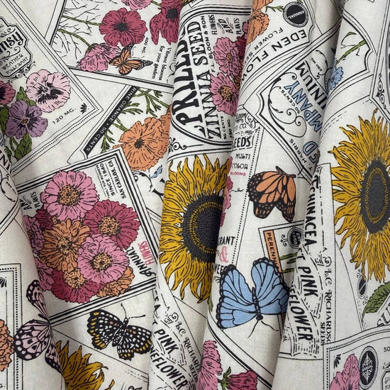 My Secret Garden by Stacy Iest Hsu for Moda 520981-11 Cloud 100% cotton fabric featuring vintage flower seed packets, colorful flowers, sunflowers and butterflies.