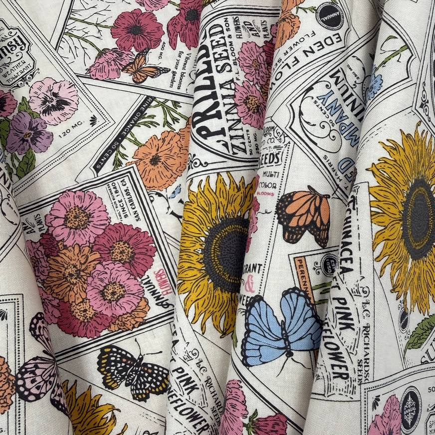 My Secret Garden by Stacy Iest Hsu for Moda 520981-11 Cloud 100% cotton fabric featuring vintage flower seed packets, colorful flowers, sunflowers and butterflies.