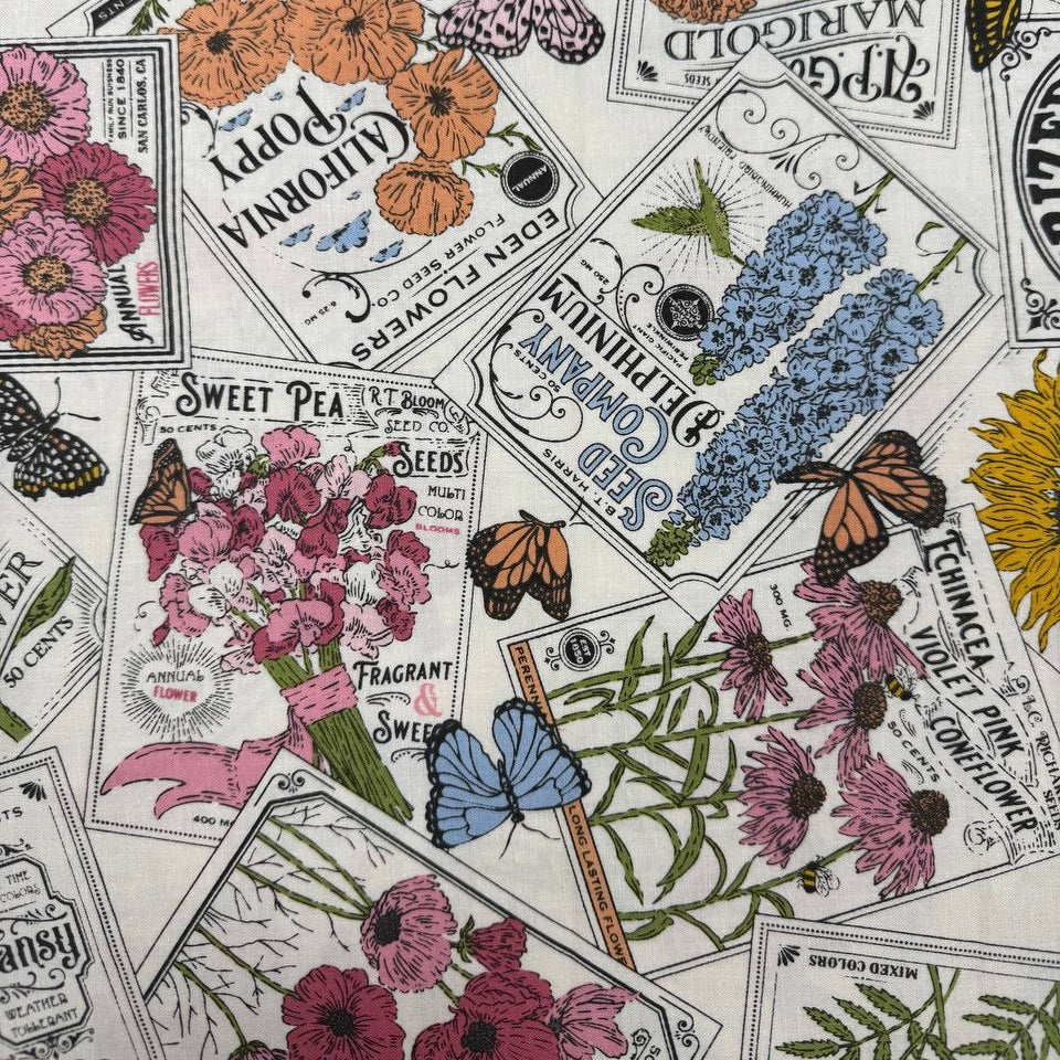 My Secret Garden by Stacy Iest Hsu for Moda 520981-11 Cloud 100% cotton fabric featuring vintage flower seed packets, colorful flowers, sunflowers and butterflies.