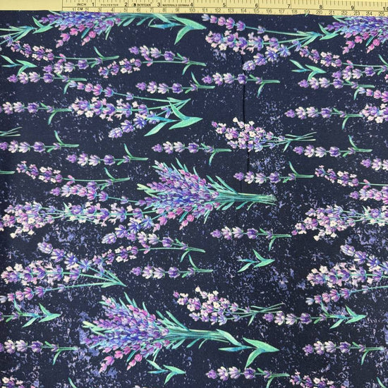 Lilac Lavender by STOF 100% cotton fabric with purple and lilac lavender flowers and green leaves on a deep navy blue background.