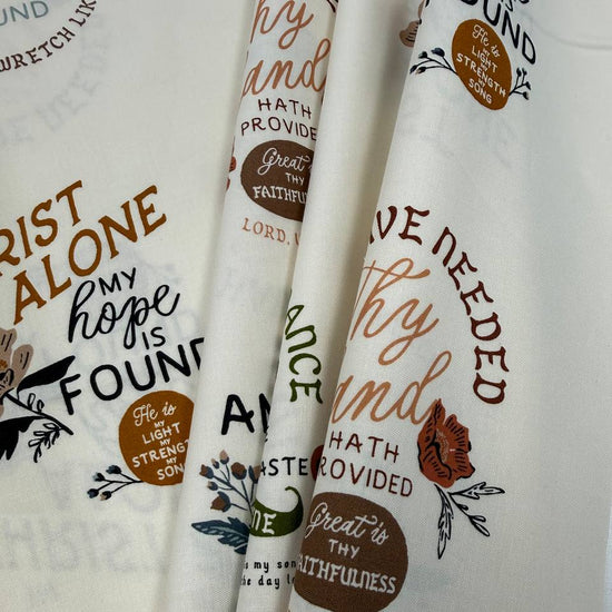 Wellspring by Fancy That Design House for Moda 100% cotton fabric with Christian inspirational and hymn phrases, floral accents and multicolor typography on a cream background.