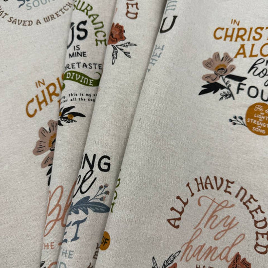 Wellspring Christian fabric panel by Fancy That Design House for Moda Fabrics featuring inspirational faith quotes and floral designs on a natural linen-look background.