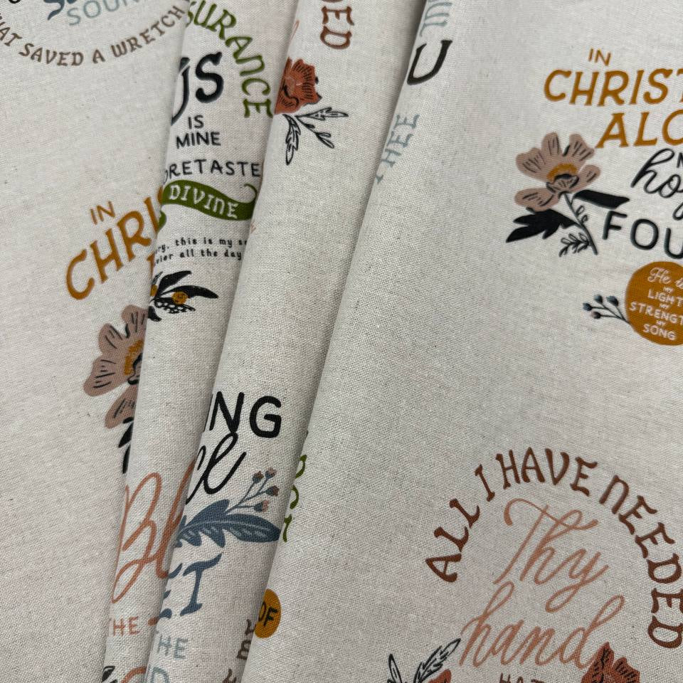 Wellspring Christian fabric panel by Fancy That Design House for Moda Fabrics featuring inspirational faith quotes and floral designs on a natural linen-look background.