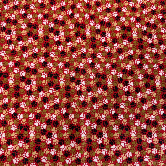 All-over paw print cotton fabric with a scattered animal footprint pattern.