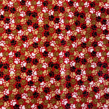 All-over paw print cotton fabric with a scattered animal footprint pattern.
