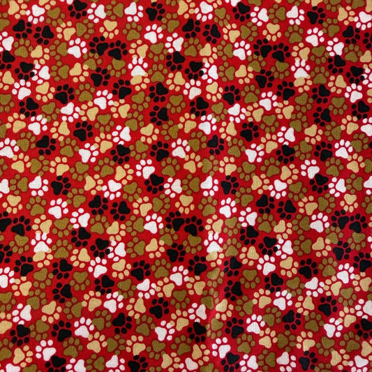 All-over paw print cotton fabric with a scattered animal footprint pattern.