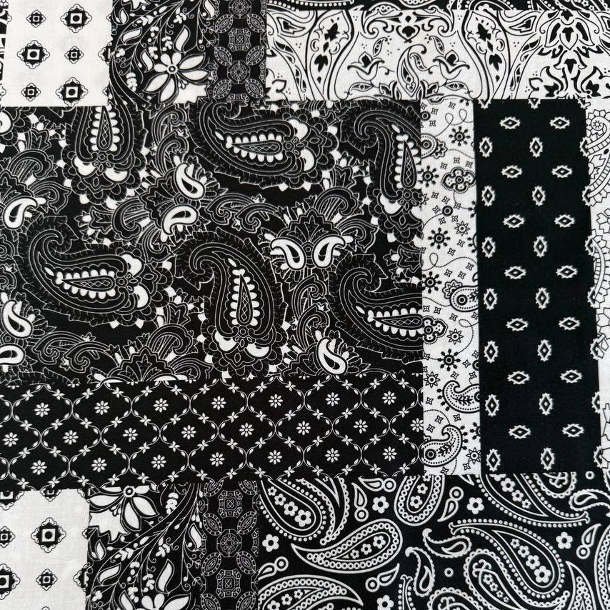 Quilting cotton fabric featuring a patchwork collage of paisley, floral, geometric, and bandana-inspired patterns arranged in contrasting blocks.