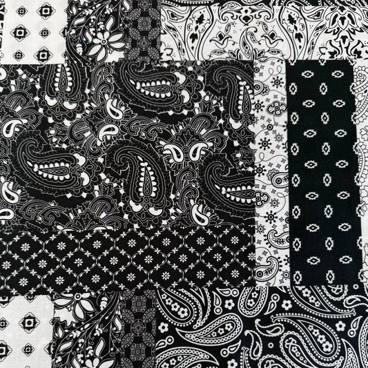 Quilting cotton fabric featuring a patchwork collage of paisley, floral, geometric, and bandana-inspired patterns arranged in contrasting blocks.