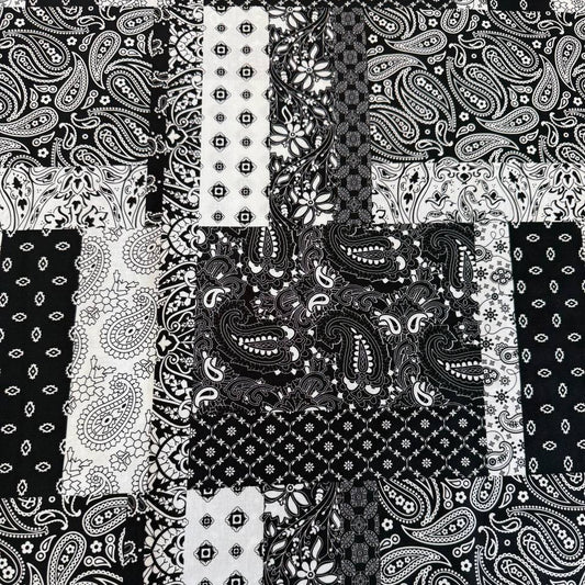 Quilting cotton fabric featuring a patchwork collage of paisley, floral, geometric, and bandana-inspired patterns arranged in contrasting blocks.