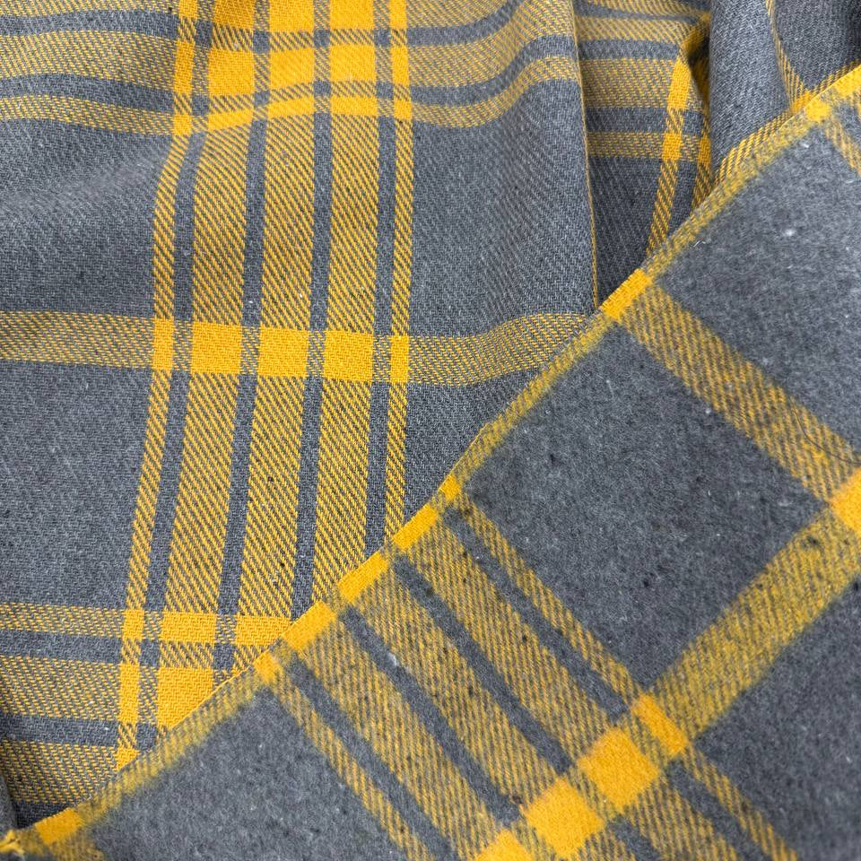 Mustard yellow and charcoal grey yarn dyed plaid fabric, 65% polyester and 35% rayon, 60 inches wide.