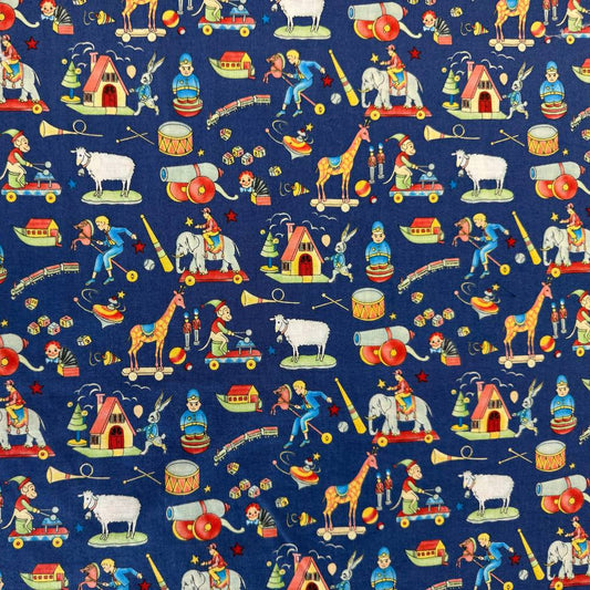 Navy blue cotton fabric featuring vintage toy illustrations including elephants, giraffes, trains, drums, rocking horses, and toy houses.