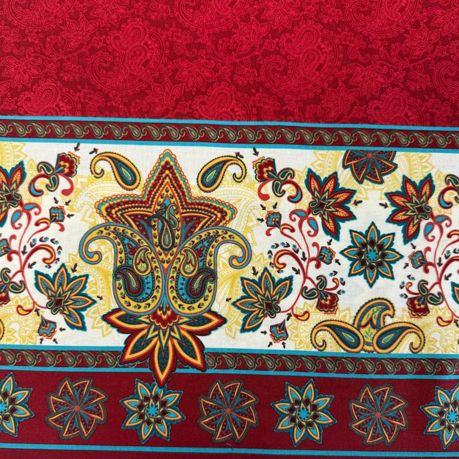 Red paisley fabric panel with decorative cream border featuring colorful floral and paisley motifs.