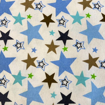 White flannelette fabric with blue, brown, navy, and green star print on a soft cotton blend background.