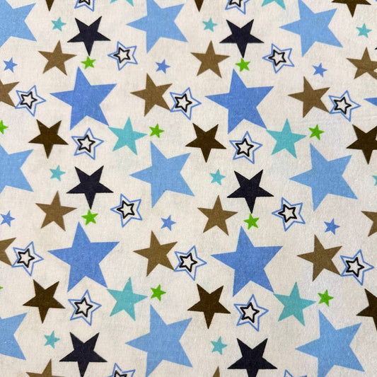 White flannelette fabric with blue, brown, navy, and green star print on a soft cotton blend background.