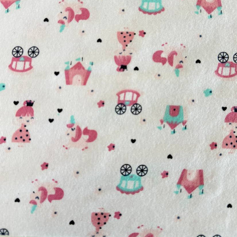 Soft white flannelette fabric featuring pink princesses, unicorns, castles, carriages, dresses, and crowns in a whimsical fairytale print.