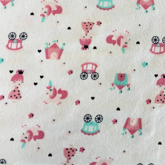 Soft white flannelette fabric featuring pink princesses, unicorns, castles, carriages, dresses, and crowns in a whimsical fairytale print.