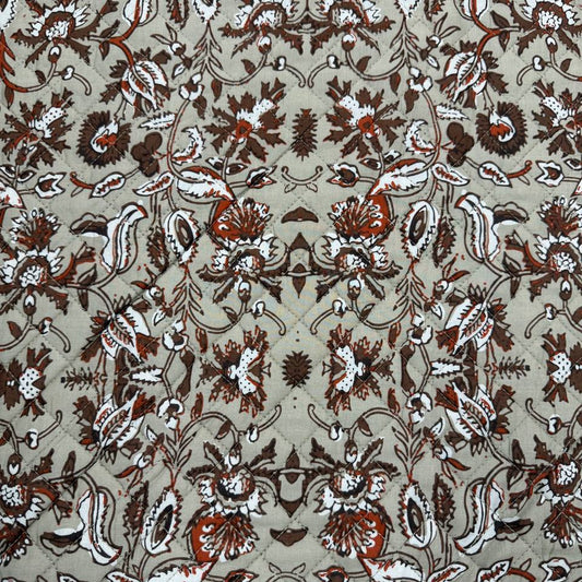 Double-sided quilted cotton fabric with brown floral print and coordinating small geometric print
