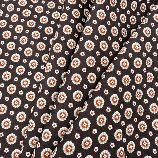 Lightweight brown 100% cotton fabric with small cream and rust geometric print