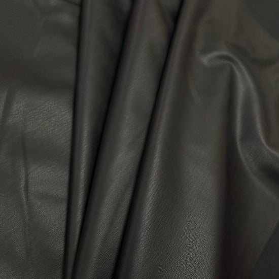 Soft PU Britney faux leather fabric with smooth PU leather-look front and soft suede-like backing, available in Black, Navy, Cognac and Sand.