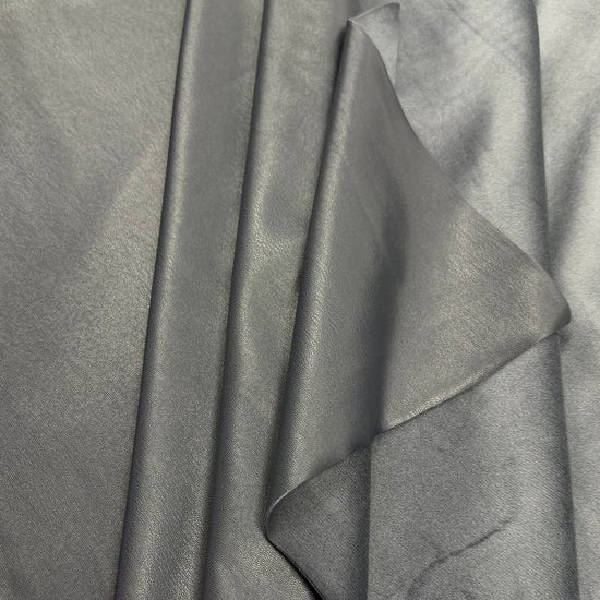 Soft PU Britney faux leather fabric with smooth PU leather-look front and soft suede-like backing, available in Black, Navy, Cognac and Sand.