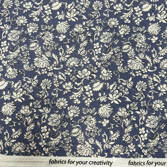 Blue 100% cotton twill fabric with an intricate ivory floral and botanical print.