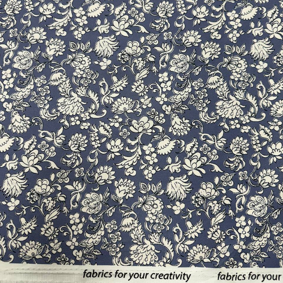 Blue 100% cotton twill fabric with an intricate ivory floral and botanical print.