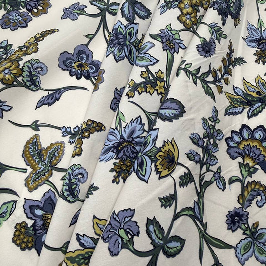 Lightweight 100% cotton poplin fabric with blue, green and mustard floral paisley print on a cream background.