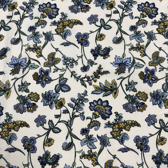 Lightweight 100% cotton poplin fabric with blue, green and mustard floral paisley print on a cream background.