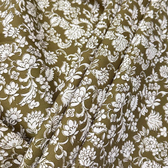 Olive green 100% cotton twill fabric with an intricate white floral and botanical print.