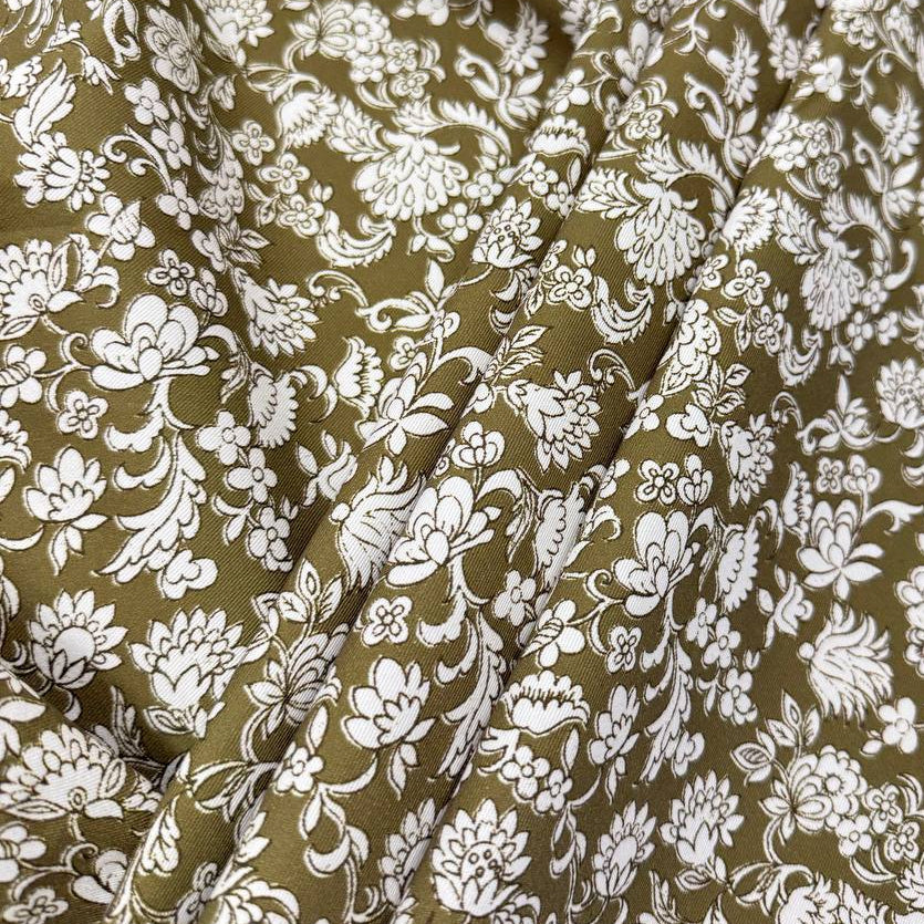 Olive green 100% cotton twill fabric with an intricate white floral and botanical print.