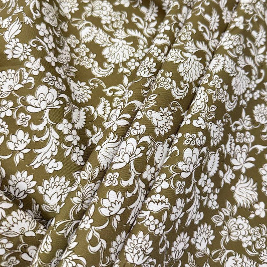 Olive green 100% cotton twill fabric with an intricate white floral and botanical print.