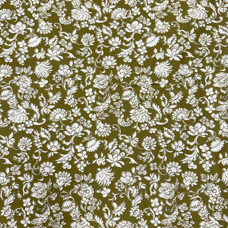 Olive green 100% cotton twill fabric with an intricate white floral and botanical print.