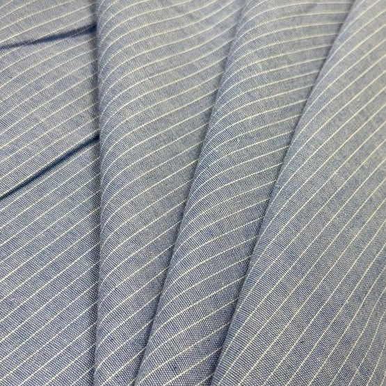 Blue pinstripe denim fabric with fine white stripes, 65% cotton and 35% polyester, 150 cm wide.
