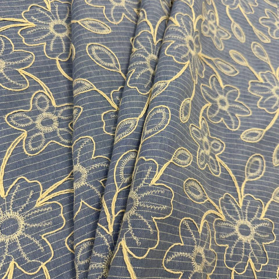 Denim blue pinstripe fabric with cream floral embroidery, 35% cotton and 65% polyester, 150 cm wide