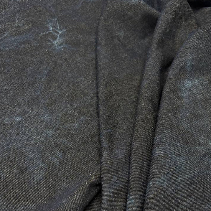 Dark blue denim fabric with light blue tie-dye effect, 85% cotton and 15% polyester, 180 cm wide