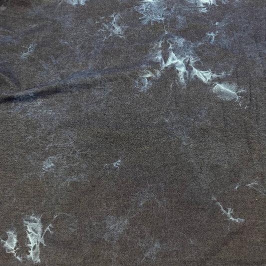 Dark blue denim fabric with light blue tie-dye effect, 85% cotton and 15% polyester, 180 cm wide