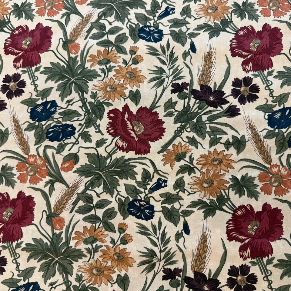 Wheatland floral quilting cotton fabric by Kansas Troubles Quilters for Moda Fabrics featuring vintage flowers, foliage, and wheat motifs in Wheat and Slate colorways.