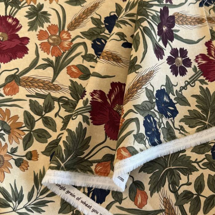 Wheatland floral quilting cotton fabric by Kansas Troubles Quilters for Moda Fabrics featuring vintage flowers, foliage, and wheat motifs in Wheat and Slate colorways.