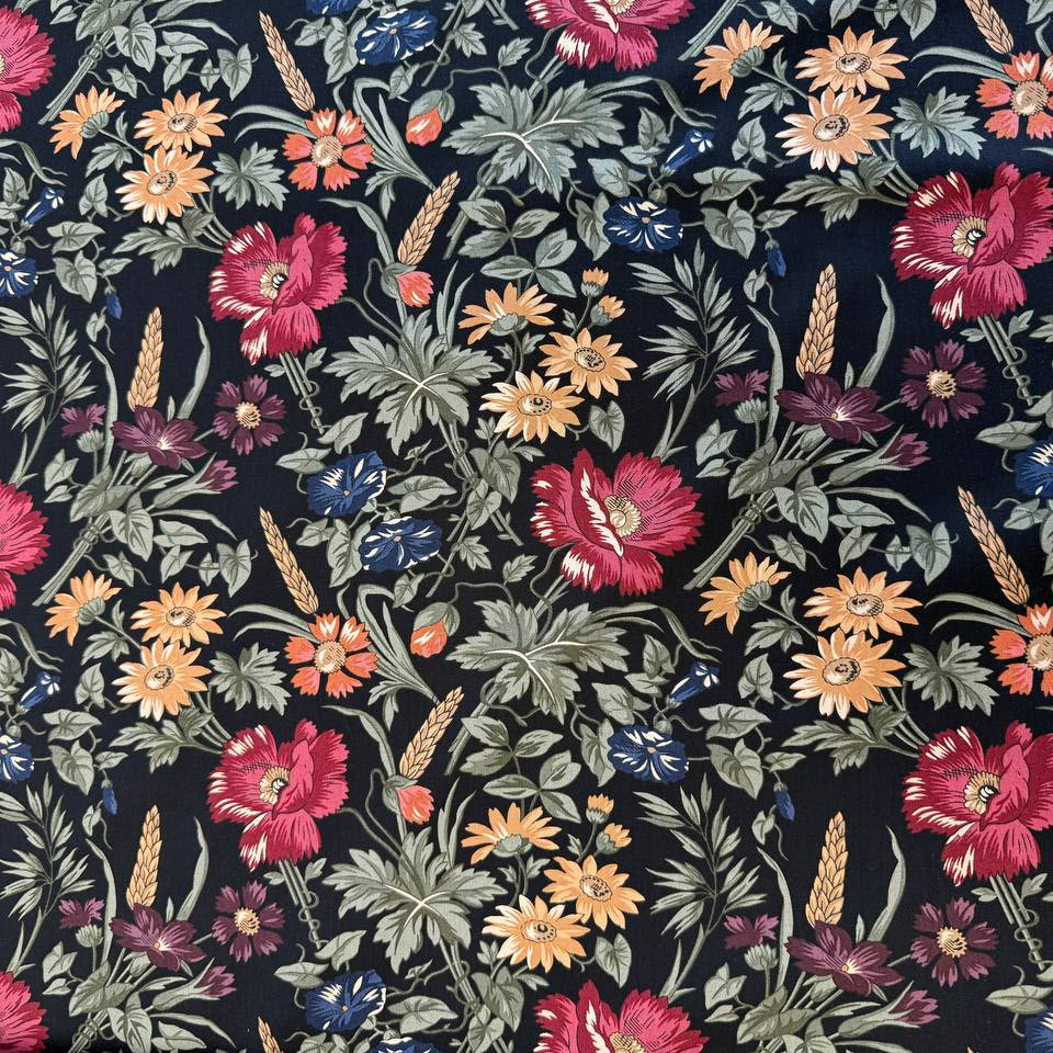 Wheatland floral quilting cotton fabric by Kansas Troubles Quilters for Moda Fabrics featuring vintage flowers, foliage, and wheat motifs in Wheat and Slate colorways.