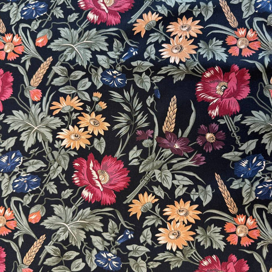 Wheatland floral quilting cotton fabric by Kansas Troubles Quilters for Moda Fabrics featuring vintage flowers, foliage, and wheat motifs in Wheat and Slate colorways.