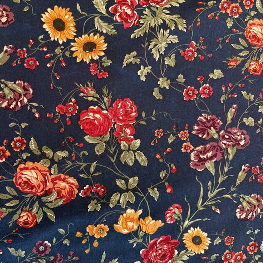 Bluebell floral quilting cotton fabric from the Daisy Lane collection by Kansas Troubles Quilters for Moda Fabrics featuring roses, daisies, and delicate blossoms on a deep blue background.