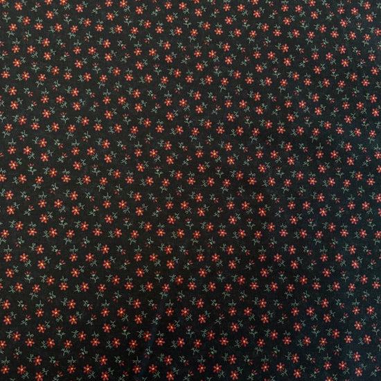 Small floral quilting cotton fabric from the Daisy Lane collection by Kansas Troubles Quilters for Moda Fabrics featuring scattered blossoms in Carnation and Mulch colorways.